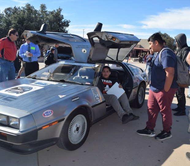 Students at A.B. Miller High School in Fontana examine a 1981 DeLorean DMC-12 – a replica of the time machine from the movie “Back to the Future” – on display at the school’s auto tech fair Dec. 11. (Courtesy photo)